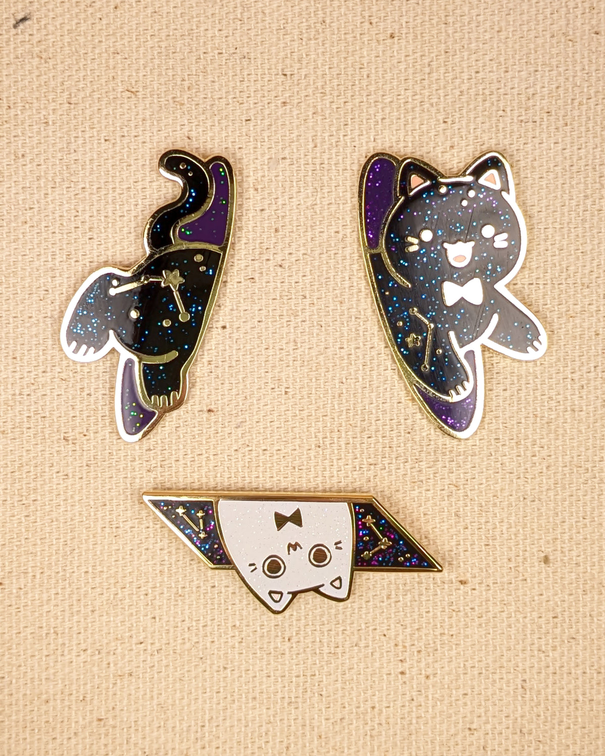 Black cat pin sitting on pin board. Glittery with space details