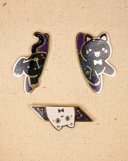Black cat pin sitting on pin board. Glittery with space details