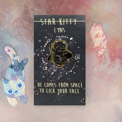 Star Kitty enamel pin on a card with space-themed design